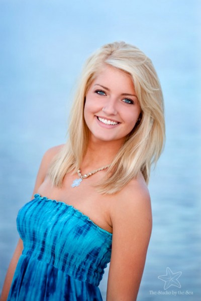 High school senior in front of water
