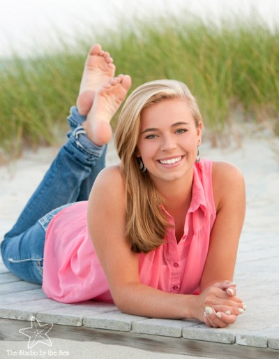 high school girl on beach lying on tummy
