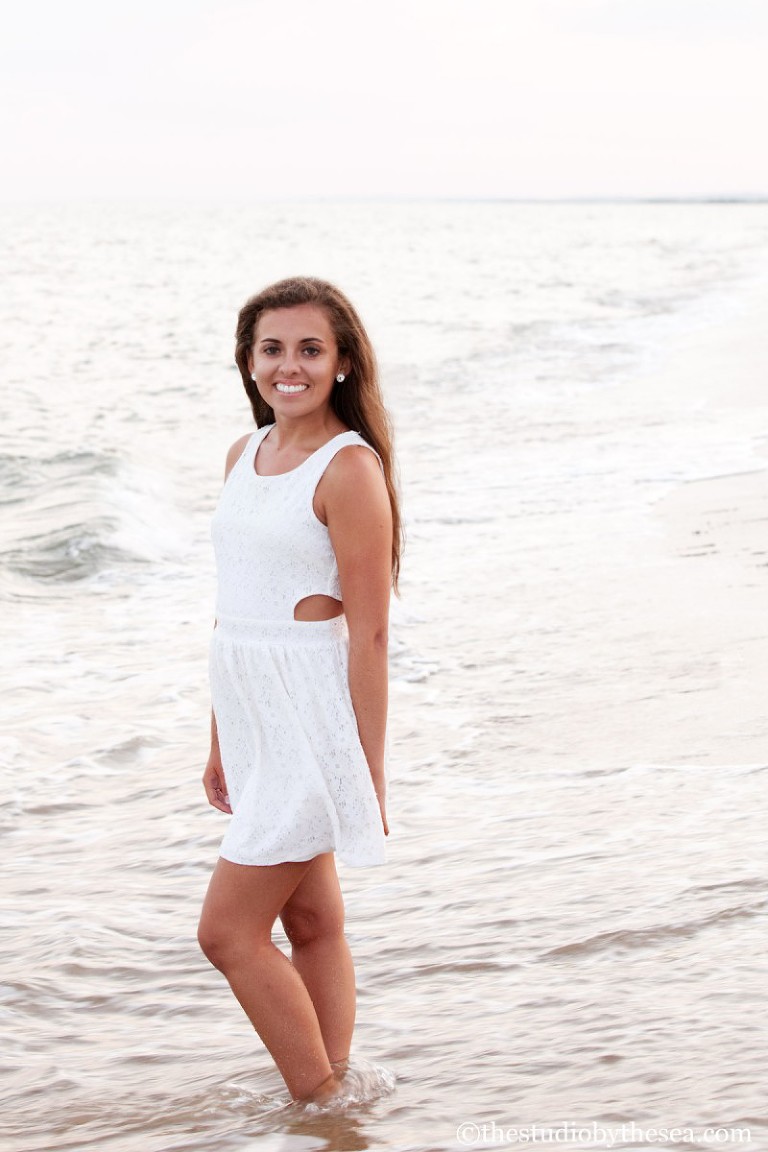 girl in dress with toes in water