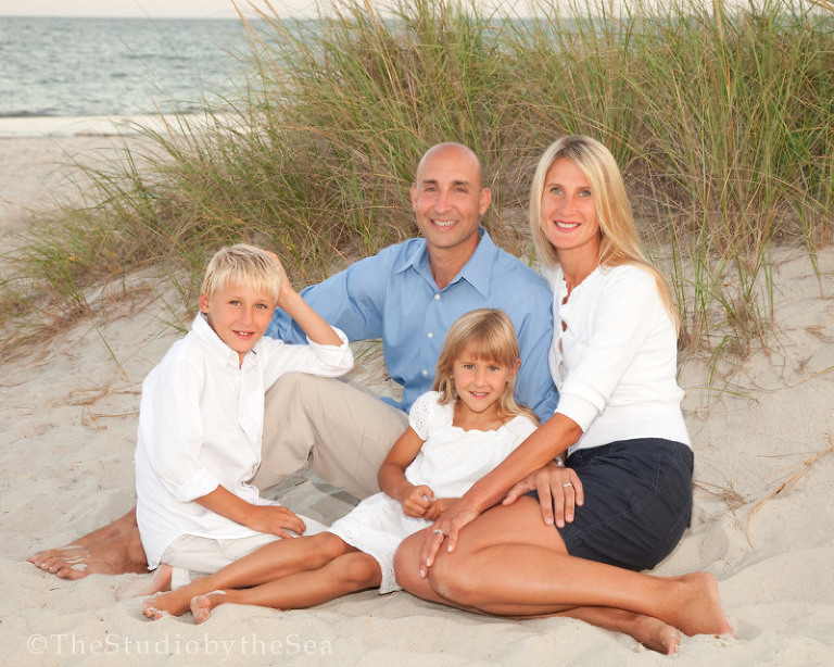 family of four portrait on the beach