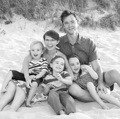 family laughing on the beach