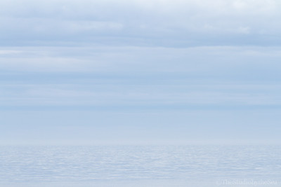 Light blue sea fading into light blue sky