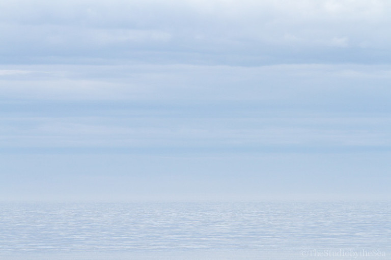 Light blue sea fading into light blue sky