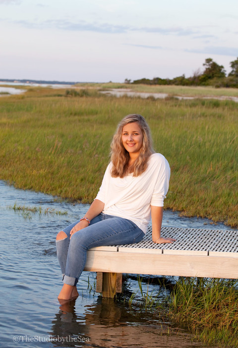 Teen girl sitting on dock