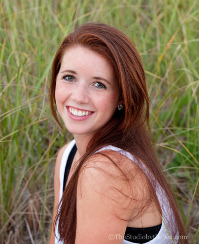 teen with freckles in beach grass