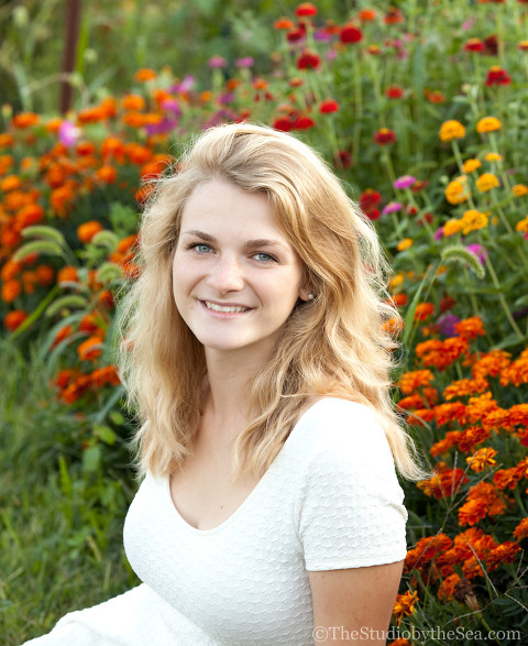 Teen in front of flower bed