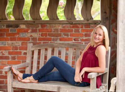 Senior girl laying on bench