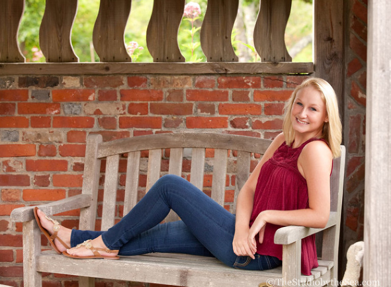 Senior girl laying on bench