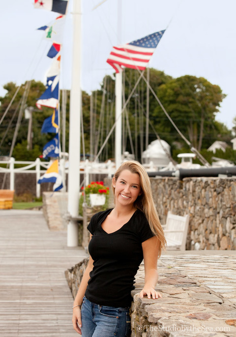 Teen standing in front of nautical flags