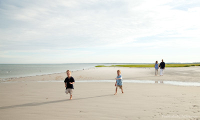 two boys running on beach