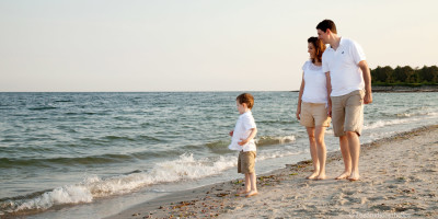 family walking along shore line