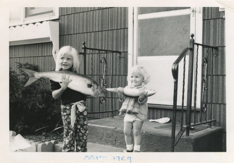 Old photo young girls holding big fish